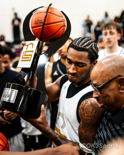 FORESTVILLE, Md. — Jasiah Cannady lifts the MVP trophy after being named Most Valuable Player of the Lethal Shooter All-Star Game at Bishop McNamara High School as teammates gather around him following the game. Photo by Olen Kelley III/OK3Sports.