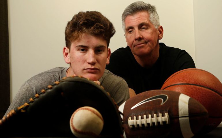 Aidan Cullen -- shown with his father, Mark -- was a three-sport athlete as a child but has since been diagnosed with a neurological disorder called Central Pain Syndrome. He still plays baseball at Windward. (Mel Melcon / Los Angeles Times)