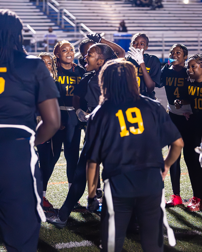 Natalie Kelley brings energy to a Wise flag football team huddle.