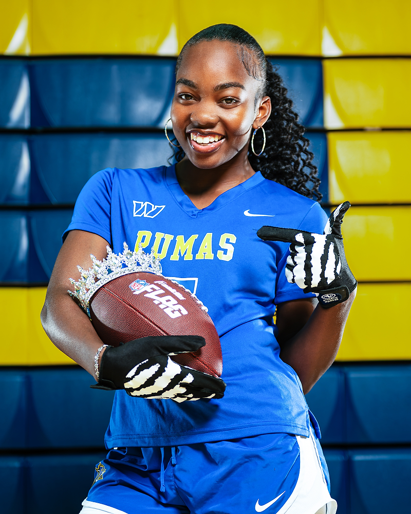 Natalie Kelley poses with a football and crown in her Wise uniform.