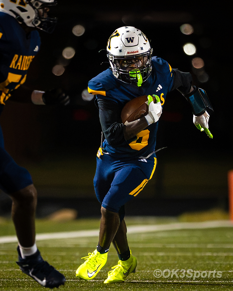 Jordan Wilson runs after a catch wearing lime-green cleats against Airport football