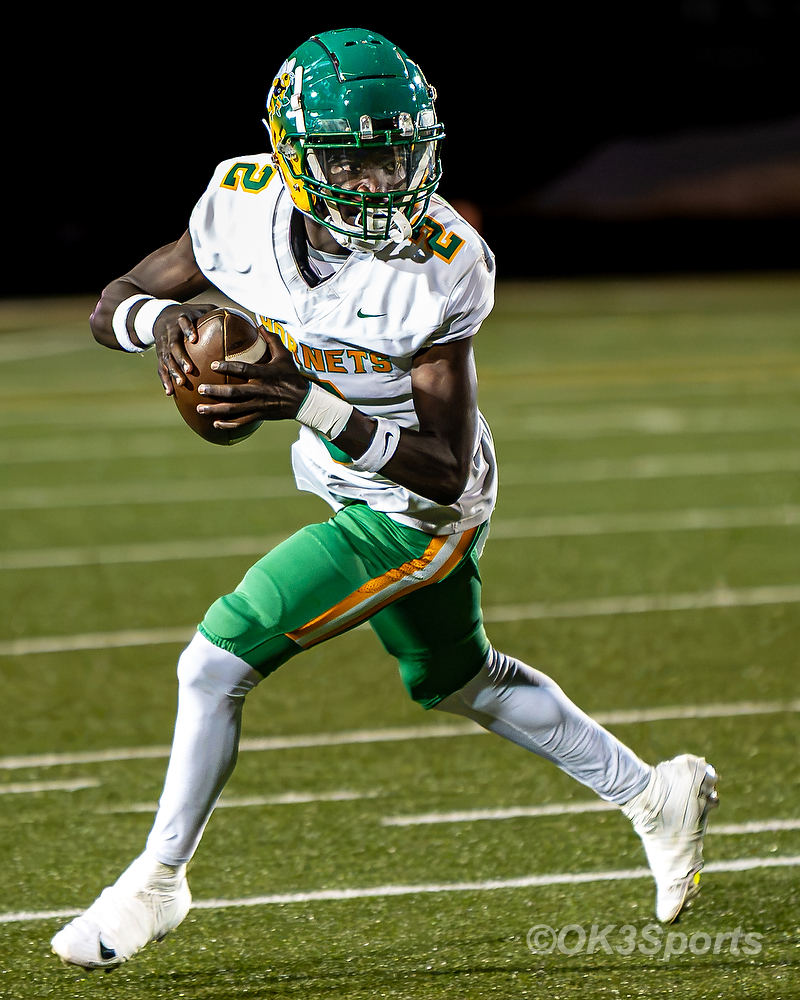 C.A. Johnson junior QB Stacey Isaac rolls out with the ball