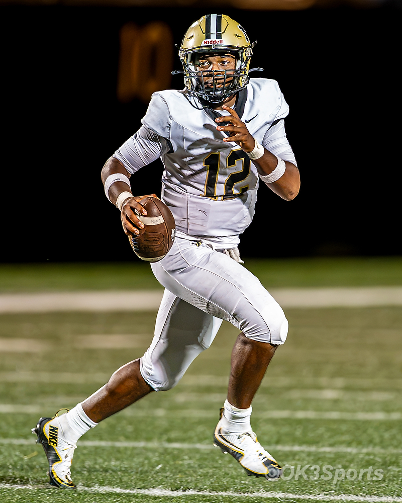 North Augusta quarterback Collin Tillman (#12) scrambles behind the line of scrimmage looking to throw against Irmo
