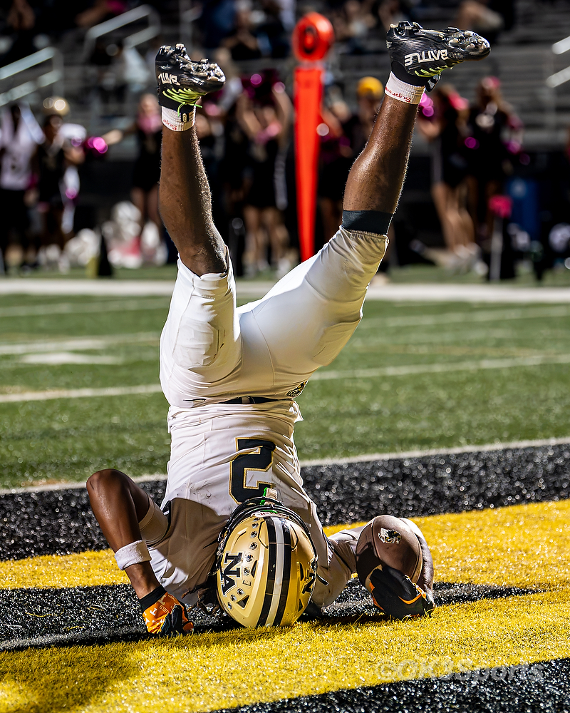 Receiver #2 flips upside down in the end zone with the ball after a touchdown